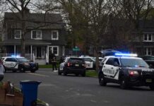 Mystery Nude Rider Dodges Police Again Police SUVs with lights on block a suburban street