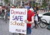 Union Endorsement: NYC Teachers Faces Power Struggle Protester holding a sign at a city street demonstration