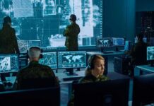 NATO Faces New Warning Over Russian Hybrid Activity Military analysts monitor data on multiple screens in a command center