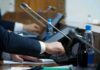 Europe Draws New AI Boundaries Person pressing a button on a conference microphone panel