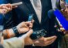 Leaked Audio Rocks Nebraska Senate Race businessperson in suit surrounded by microphones and recorders