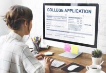 Student completing a college application on a desktop computer
