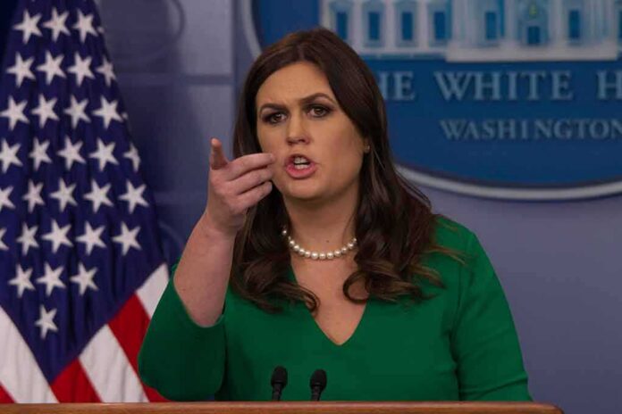 woman speaking at a press briefing podium