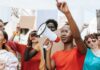 Viral Piker Clip Raises Questions About Activist Power Protester with megaphone leading a crowd