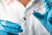 Experimental Drug Targets Deep Belly Fat Gloved hands drawing liquid into a syringe from a vial