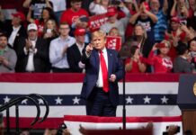 Supreme Court Talk Sparks Rally Buzz Donald Trump points from a rally stage; Rudi Koertzen and Bear Pascoe are in the crowd