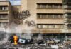 France Balances Public Safety and Protest Rights Burning overturned police car in front of a damaged building