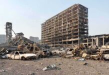 Fatal Crash Car Catches Fire Again Weeks Later Burned-out cars amid a gutted high-rise building