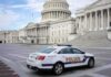100+ White Powder Letters Spark Federal Probe Police car parked outside the United States Capitol building