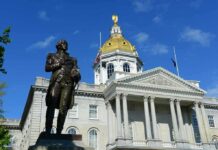 Bronze statue before a domed capitol building