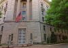 Citizenship Case Faces High Legal Bar Stone government building with American flag at entrance