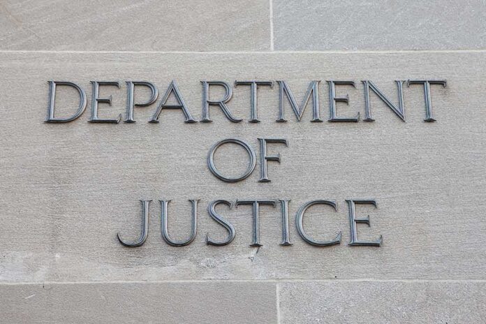 shutterstock_506478736-1 Department of Justice inscription on stone wall