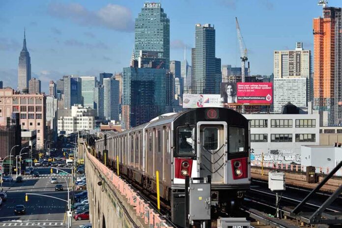 shutterstock_646635184 NYC subway 7 train on elevated tracks with city skyline