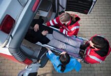 Wrestling Legend Hospitalized After Tampa Fall Paramedics load a patient on a stretcher into an ambulance